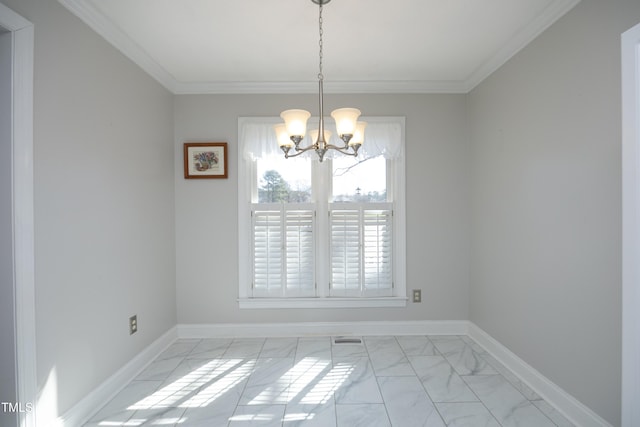 empty room with crown molding, a notable chandelier, baseboards, and marble finish floor