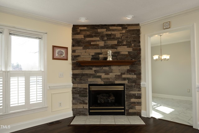 interior details featuring visible vents, wood finished floors, a fireplace, and crown molding