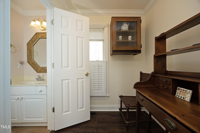 home office with dark wood finished floors, ornamental molding, baseboards, and a sink