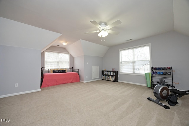 bedroom featuring multiple windows, light carpet, and vaulted ceiling