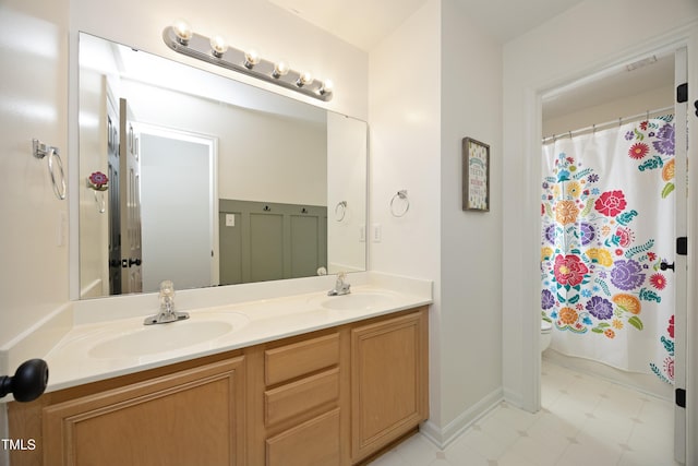 bathroom with toilet and vanity