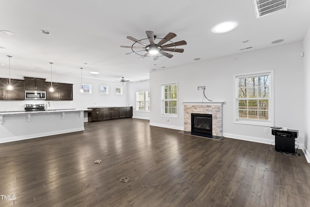 unfurnished living room featuring dark hardwood / wood-style floors and ceiling fan