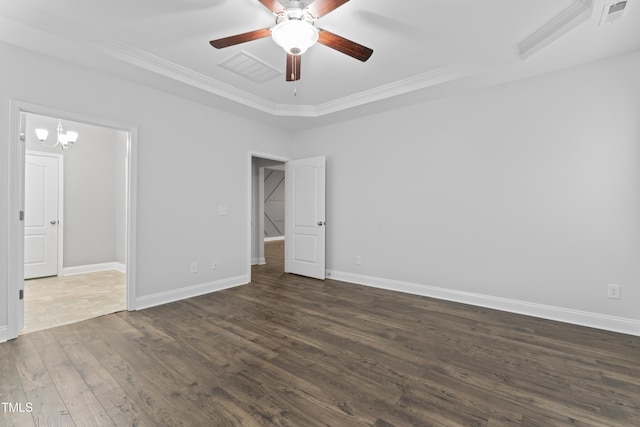 unfurnished bedroom featuring dark hardwood / wood-style flooring, ceiling fan with notable chandelier, and crown molding