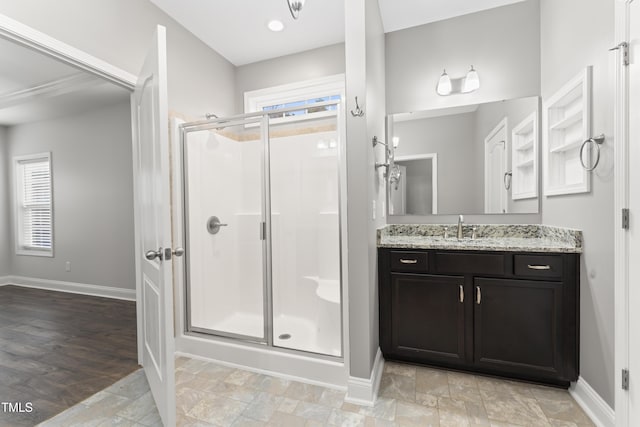 bathroom with walk in shower and vanity