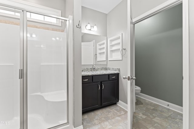 bathroom with vanity, toilet, and walk in shower