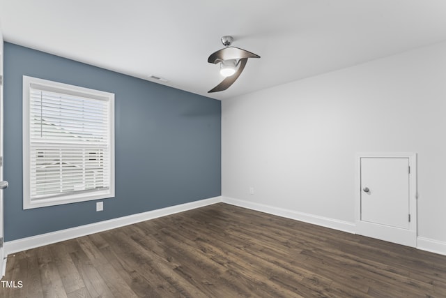 unfurnished room with dark wood-type flooring