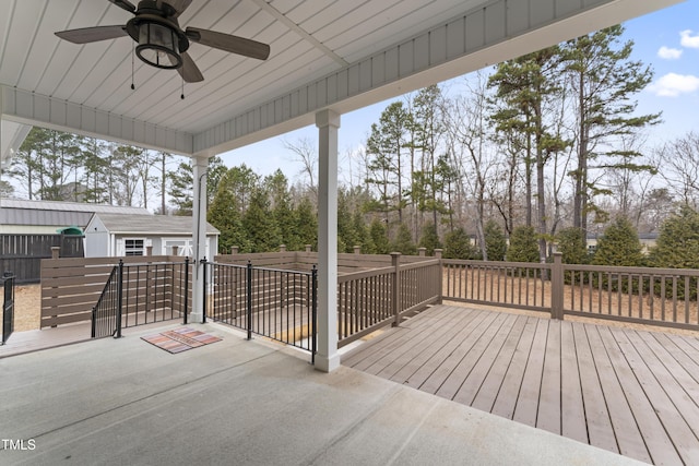 wooden terrace featuring a storage shed and ceiling fan