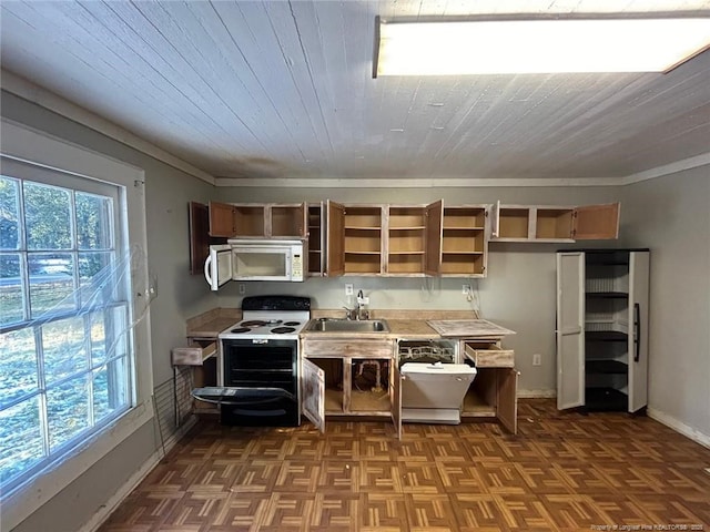 kitchen featuring white appliances, a healthy amount of sunlight, sink, and dark parquet flooring