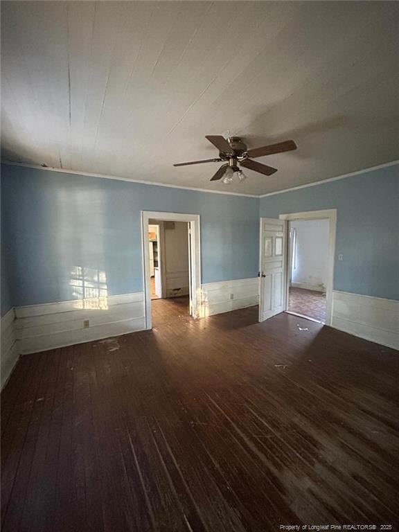 empty room featuring crown molding, ceiling fan, and wood-type flooring