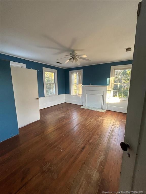 unfurnished living room with dark wood-type flooring and ceiling fan