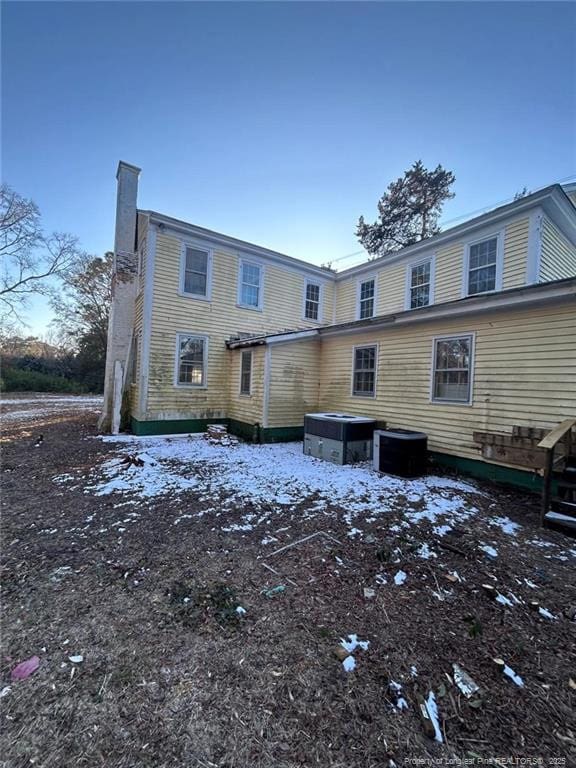 snow covered property featuring cooling unit