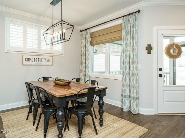 dining area featuring dark hardwood / wood-style flooring and crown molding