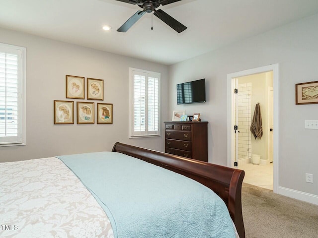 carpeted bedroom with ceiling fan and ensuite bathroom