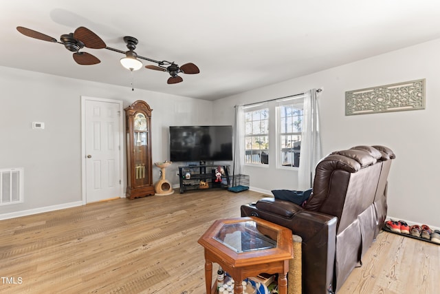 living room featuring light hardwood / wood-style flooring and ceiling fan