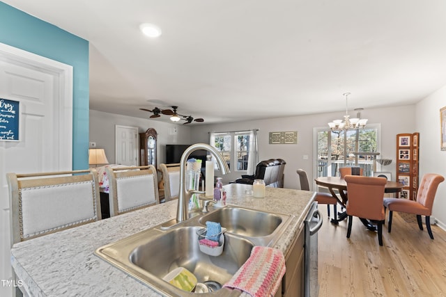 kitchen with pendant lighting, sink, a wealth of natural light, and stainless steel dishwasher