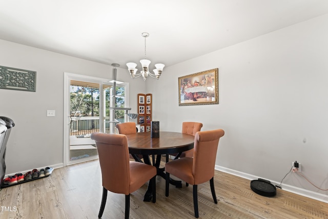 dining room featuring a chandelier and light wood-type flooring