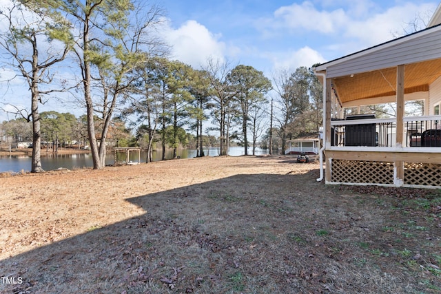 view of yard featuring a deck with water view