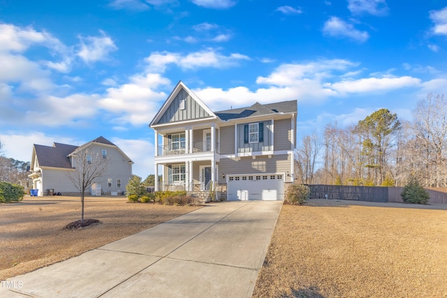 view of front facade featuring a garage, a balcony, and covered porch