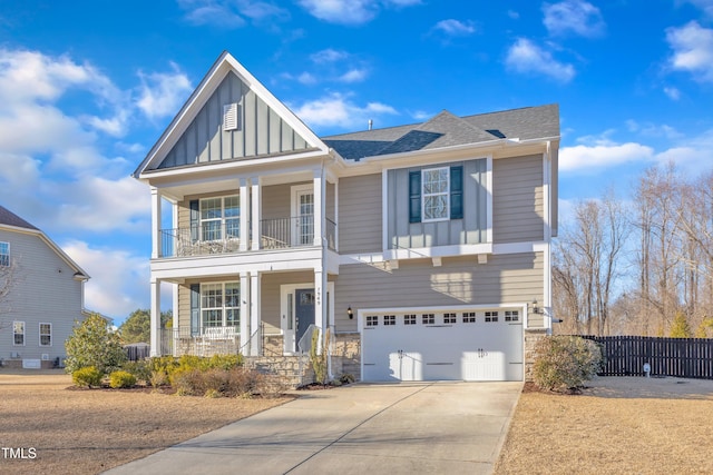 view of front of house featuring a garage, a balcony, and a porch