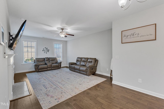 living room with ceiling fan and dark hardwood / wood-style floors