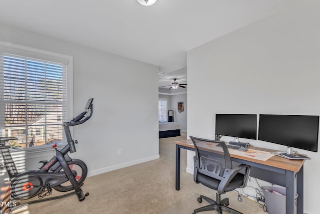 carpeted home office featuring ceiling fan