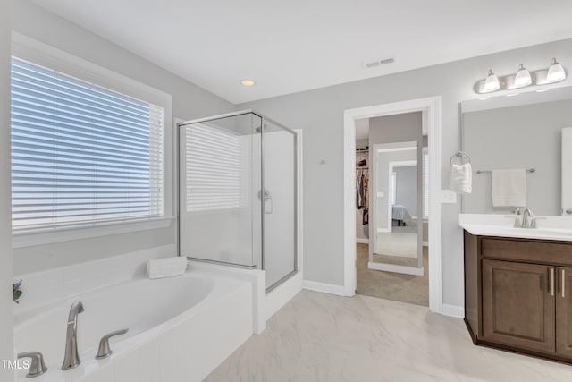 bathroom featuring vanity and shower with separate bathtub