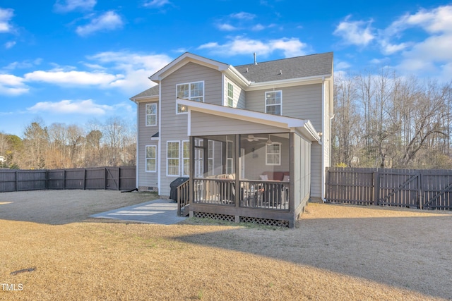 rear view of property with a patio, a sunroom, a wooden deck, and a yard