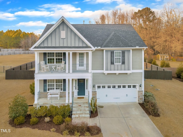 view of front of house with a garage, a balcony, and a porch