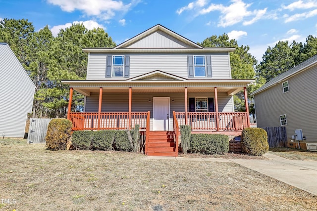 view of front of property with covered porch and a front lawn