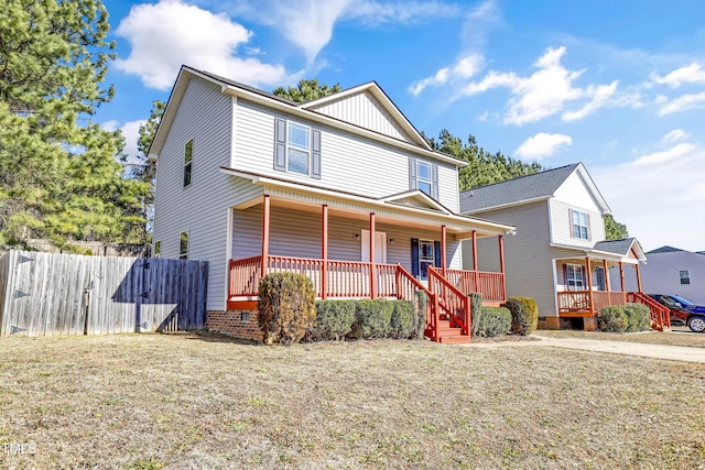 view of front of house featuring a front yard and covered porch