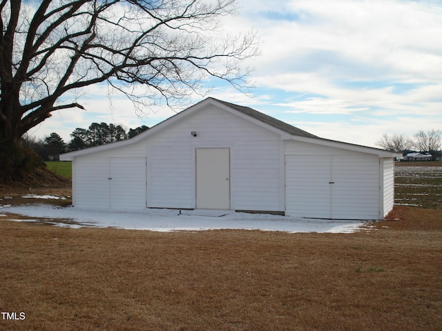 view of outbuilding with a lawn