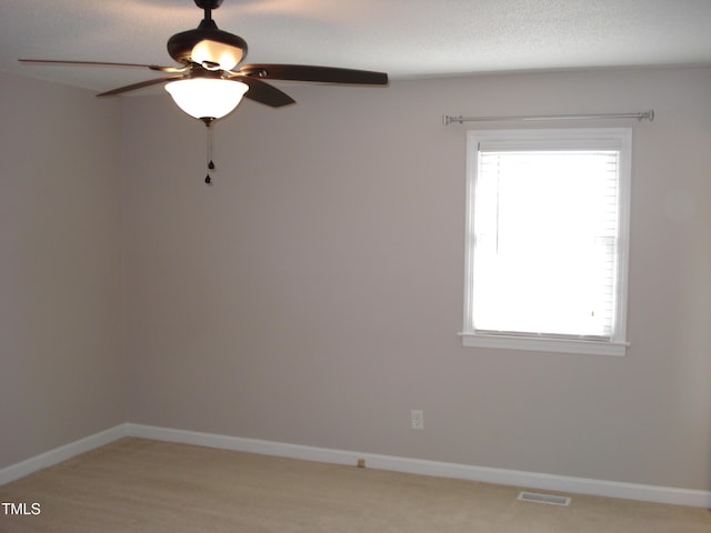 empty room with a healthy amount of sunlight and ceiling fan