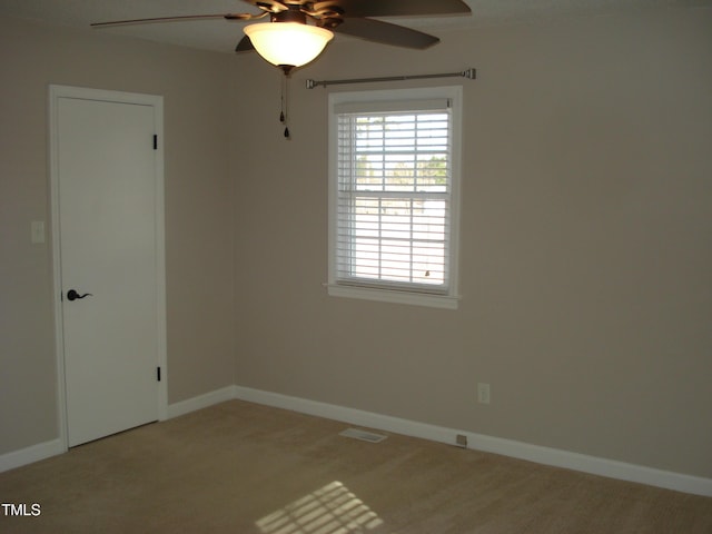 empty room featuring carpet flooring and ceiling fan