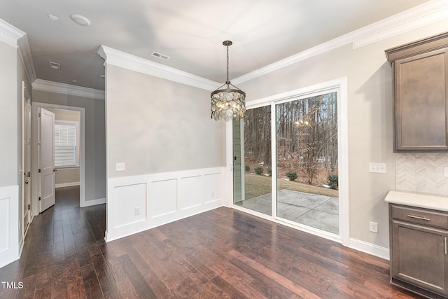 unfurnished dining area with crown molding and dark hardwood / wood-style floors