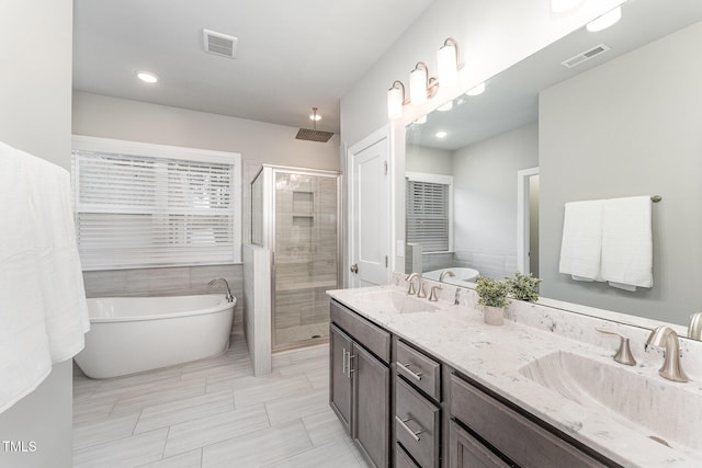 bathroom with vanity, tile patterned floors, and shower with separate bathtub