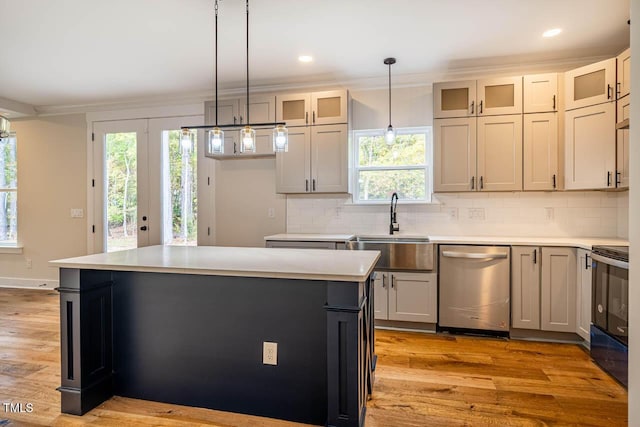 kitchen with sink, a center island, electric range, stainless steel dishwasher, and pendant lighting