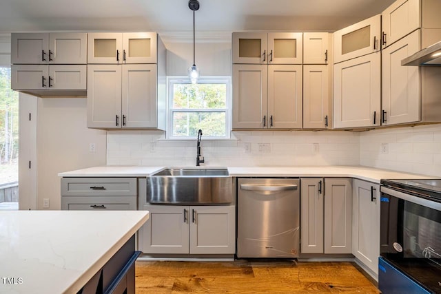 kitchen with sink, gray cabinetry, hanging light fixtures, stainless steel dishwasher, and electric stove