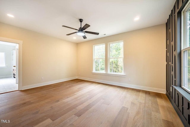 unfurnished room with ceiling fan and light hardwood / wood-style floors