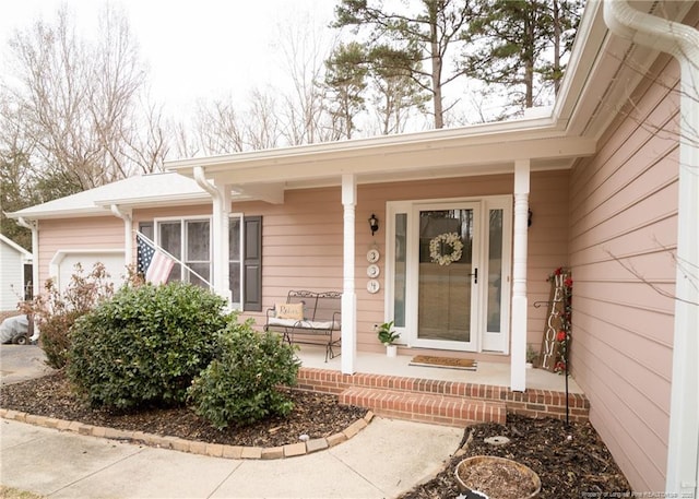 view of exterior entry featuring covered porch