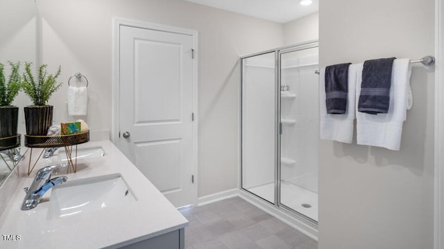 bathroom featuring vanity and a shower with door