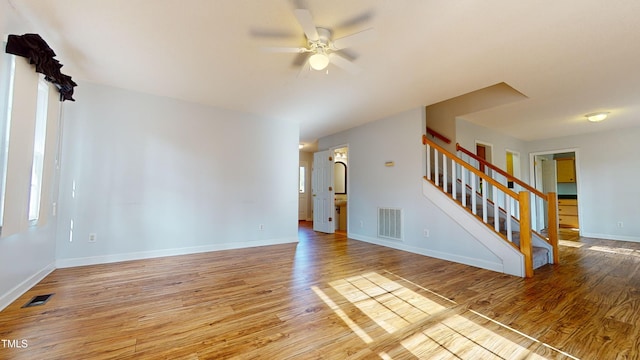 unfurnished living room featuring ceiling fan and light hardwood / wood-style floors