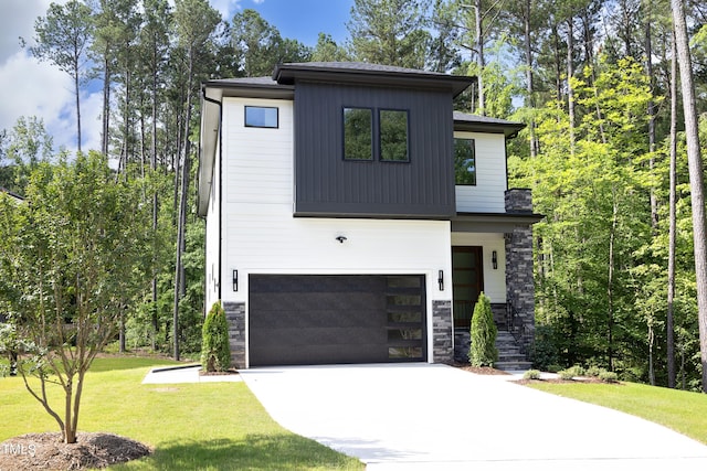 view of front of home with a garage and a front lawn