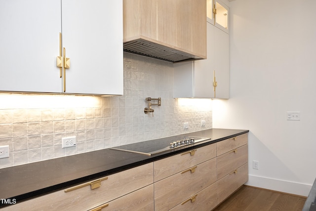 kitchen with decorative backsplash, custom exhaust hood, dark wood-type flooring, light brown cabinets, and black electric cooktop