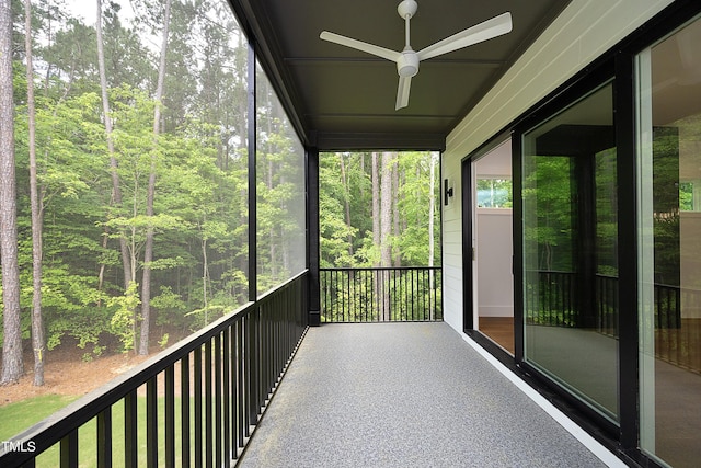 unfurnished sunroom with a wealth of natural light and ceiling fan