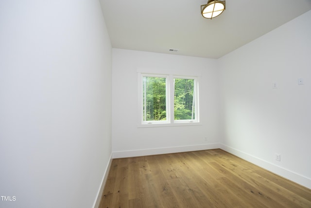 unfurnished room featuring hardwood / wood-style flooring