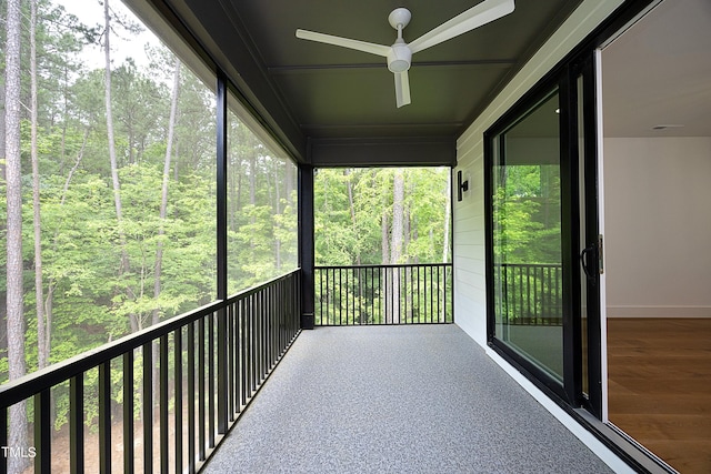 unfurnished sunroom with ceiling fan