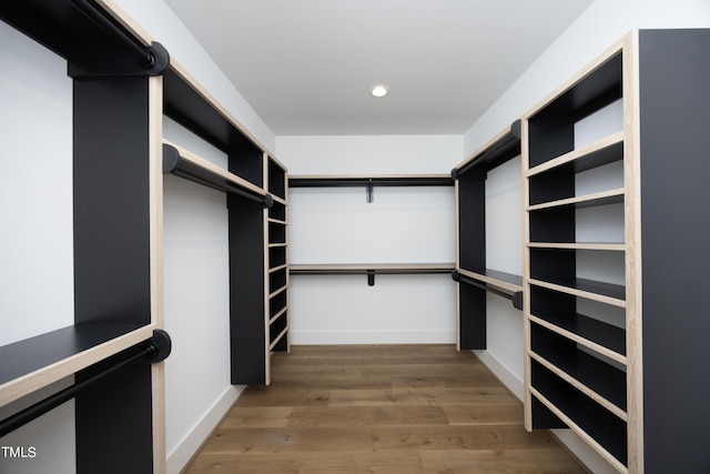 walk in closet with dark hardwood / wood-style flooring