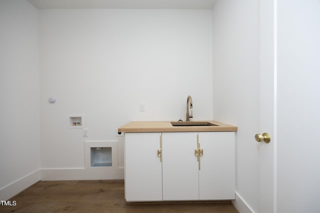 laundry area with cabinets, washer hookup, sink, and hardwood / wood-style floors