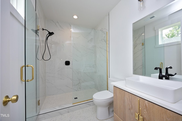 bathroom with vanity, an enclosed shower, and toilet