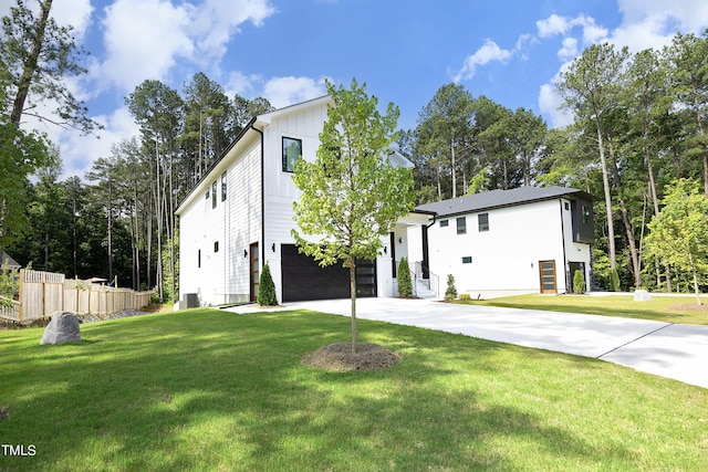 view of front of house with a garage and a front lawn